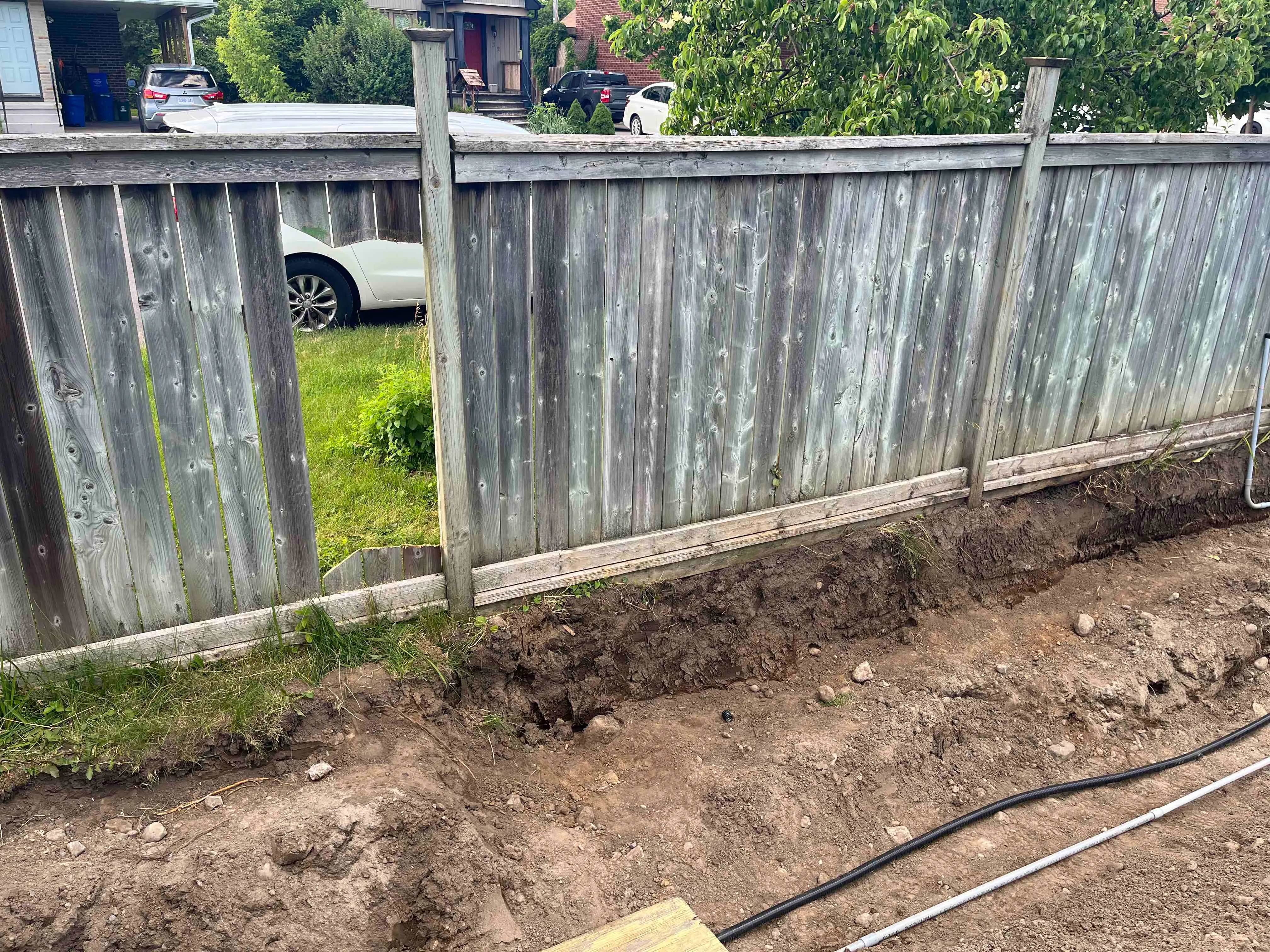 Our makeshift access route — a hole cut in the side fence
